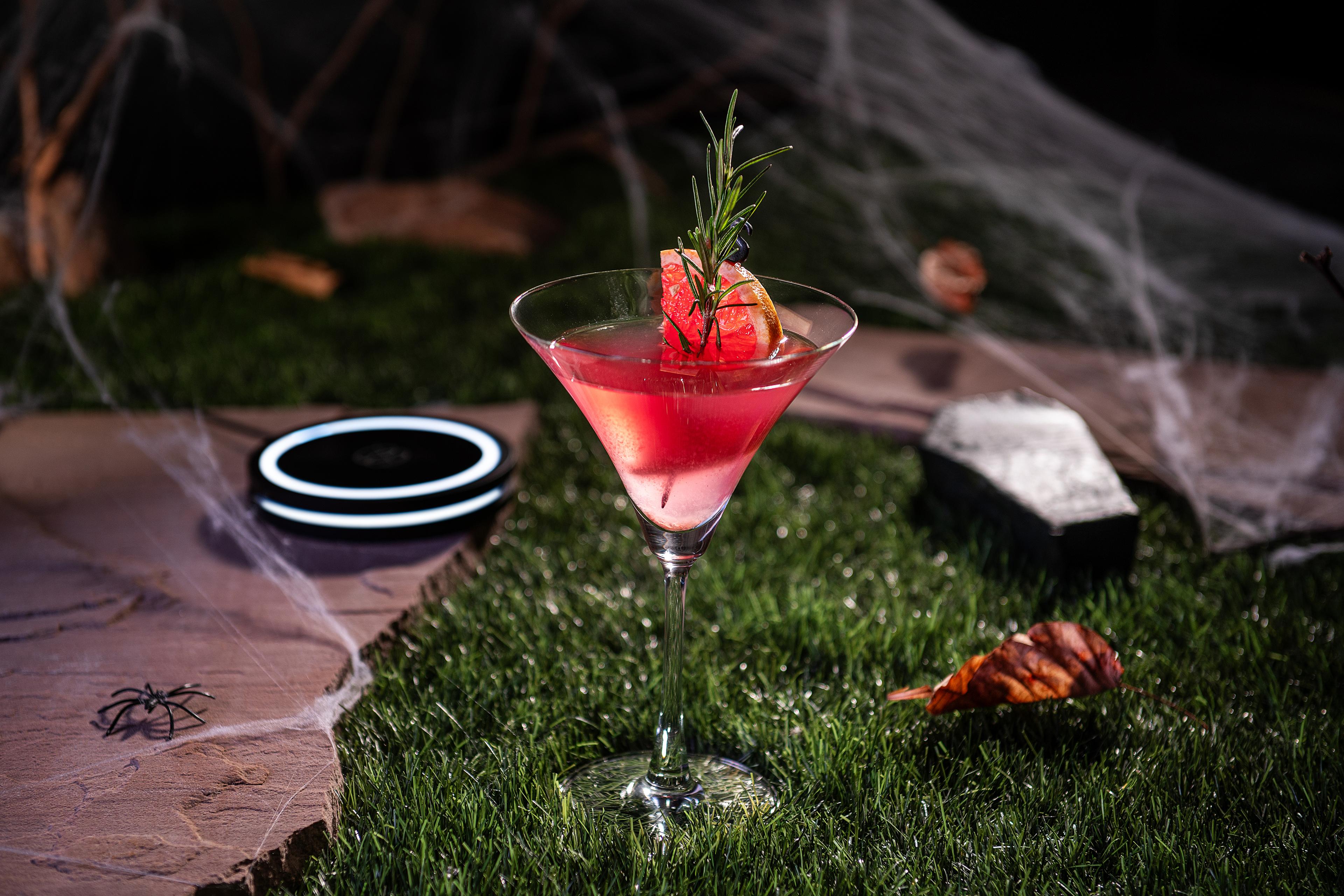 Party guest using Barsys 360 cocktail app to craft a cocktail at Halloween event