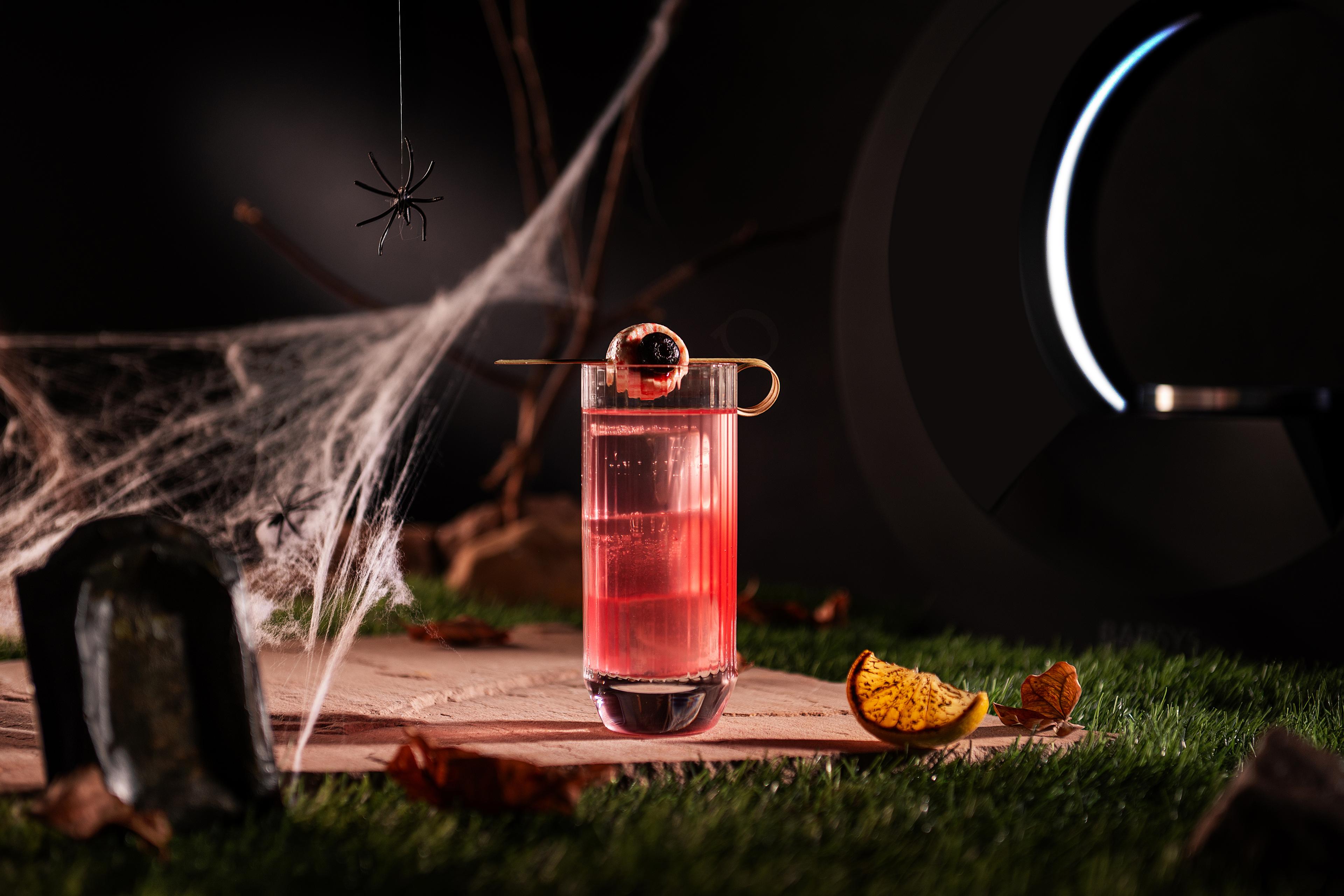 Halloween party guest using Barsys app to pour cocktail